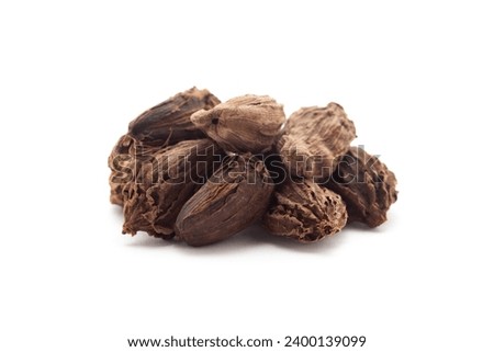 Close-up of Organic Black cardamom (Amomum subulatum)  on a white background. Pile of Indian Aromatic Spice. Front view