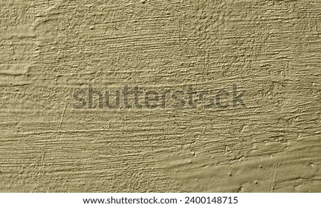 Abstract Rough Dry paint is peeling off the building wall.Close-up. Badly fixed building facade wall covered with cracks in stucco and paint. Missing patch of paint in the middle; crack with flappy. Royalty-Free Stock Photo #2400148715