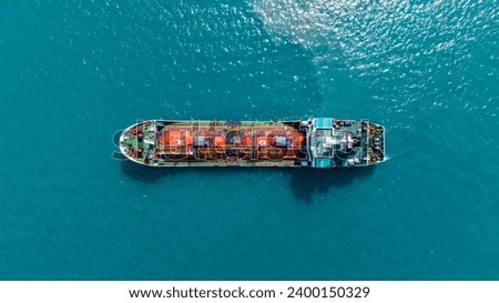 Aerial top view LPG gas ship, Ship tanker gas LPG top view on the sea for transportation, Liquefied Petroleum Gas tanker or LPG anchored in deep blue ocean sea. Royalty-Free Stock Photo #2400150329