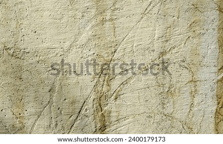 Abstract Rough Dry paint is peeling off the building wall.Close-up. Badly fixed building facade wall covered with cracks in stucco and paint. Missing patch of paint in the middle; crack with flappy. Royalty-Free Stock Photo #2400179173