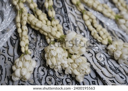 Decorative jasmine flower arrangements in Sundanese Moslem wedding dresses. Indonesian culture. Bunga Melati.  Royalty-Free Stock Photo #2400195563