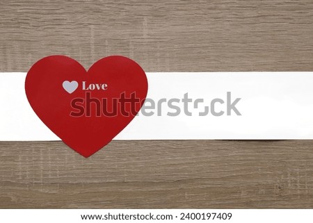 red heart sign, symbol with white paper ribbon isolated on wooden table background. mock up, empty copy space for inscription. 14th february happy Valentines day holiday, event. mockup, template