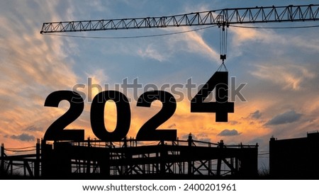 crane lifting number 4 come down to 2024 , prepare for welcome beginning new year 2024 with silhouette construction site , sunrise sky at background for start and reach new goals for year 2024. Royalty-Free Stock Photo #2400201961