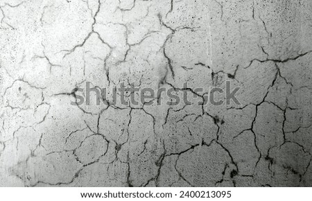 Abstract Rough Dry paint is peeling off the building wall.Close-up. Badly fixed building facade wall covered with cracks in stucco and paint. Missing patch of paint in the middle; crack with flappy. Royalty-Free Stock Photo #2400213095
