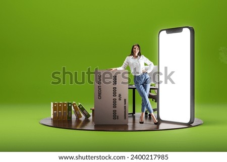 Smiling young woman standing with big credit card near giant 3D model of mobile phone with empty screen over green background. Online shopping, sales. E-commerce. Mockup for text, ad, design, logo