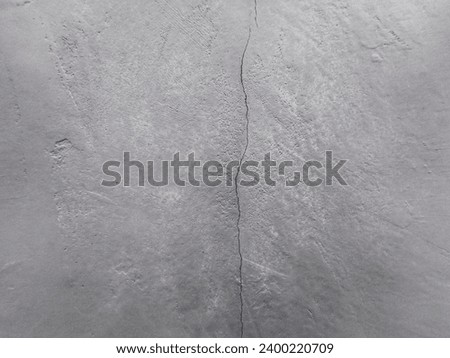 Hairline crack in grey concrete wall Royalty-Free Stock Photo #2400220709