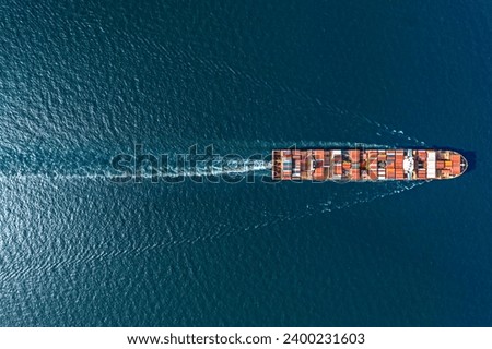 Aerial top view container ship in export and import business and logistics. Shipping cargo to harbor by crane.