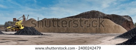 Storage of coal, lignite and ecological coconut shell briquettes. Coal loader. Heaps of coal. Royalty-Free Stock Photo #2400242479