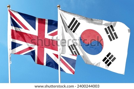 British flag and South Korean flag on cloudy sky. flying in the sky