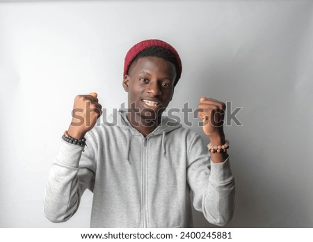 Happy cheerful young African gen Z isolated on white background. Funny smile teen student celebrates a win