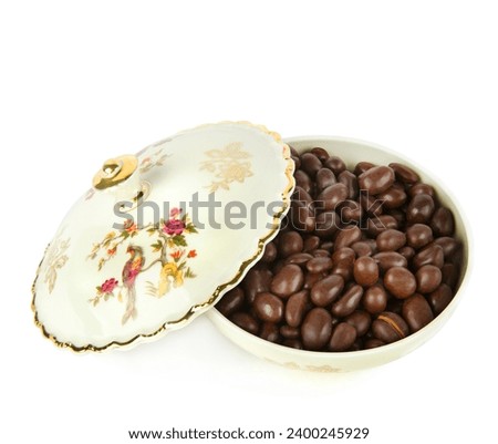 Porcelain box with chocolate dragee isolated on a white background. German vintage porcelain. Royalty-Free Stock Photo #2400245929