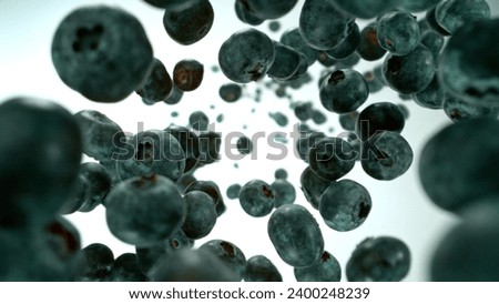 Freeze motion shot of falling and rotating blueberries, white background. Filmed on high speed cinematic camera at 1000 fps.