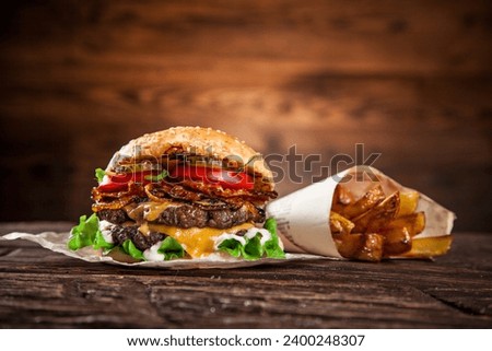 Home made hamburger with lettuce and cheese on old wooden table