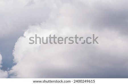 Cloudy sky background with white and gray clouds. Natural background