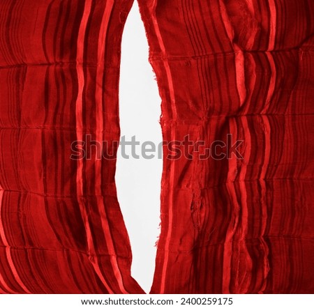 teared rag spread isolated on white background, can use like a backdrop or any texture. big hole in the tissue. striped red cotton fabric with torn stitch, hole and loose threads. mattress