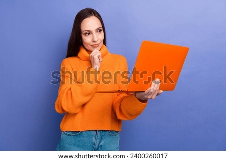 Photo of smart young business analytic working woman holding netbook touch chin makes decision isolated on violet color background