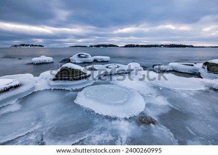 The coast of the Gulf of Finland in winter at sunset Royalty-Free Stock Photo #2400260995