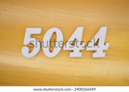 The golden yellow painted wood panel for the background, number 5044, is made from white painted wood.