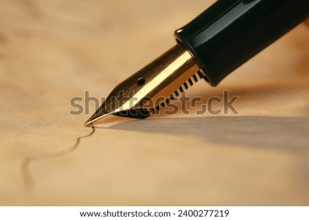 Drawing line with beautiful fountain pen, closeup Royalty-Free Stock Photo #2400277219