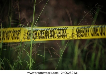 Crime Scene tape in tall green grass