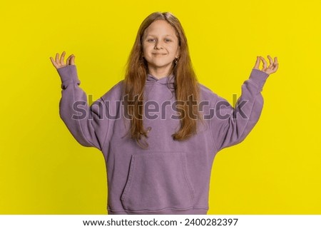 Keep calm down, relax rest. Concentrated happy smiling preteen child girl kid meditating breathes deeply with mudra yoga gesture eyes closed peaceful mind taking a break. Children on yellow background