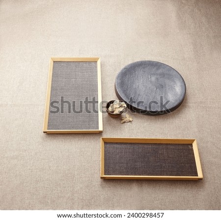 various ceramic plates and wooden plates on brown paper. An empty platform for display cosmetic products, food and props Royalty-Free Stock Photo #2400298457