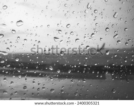 View From Airplane Cabin When Raining Outside Water Droplet On Window Abstract Pattern Infrared Black and White Colour