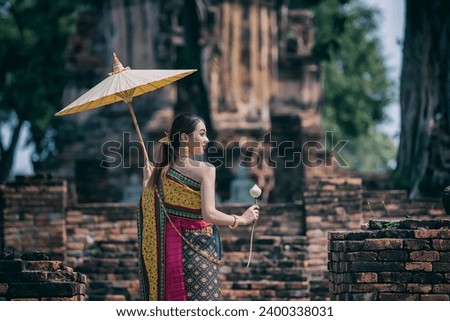  women in traditional clothing  on Buddhist on background.  Portrait women in traditional clothing , Thai traditional  in Ayutthaya, Thailand. Royalty-Free Stock Photo #2400338031