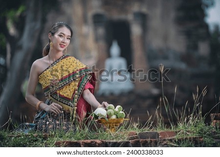  women in traditional clothing  on Buddhist on background.  Portrait women in traditional clothing , Thai traditional  in Ayutthaya, Thailand. Royalty-Free Stock Photo #2400338033