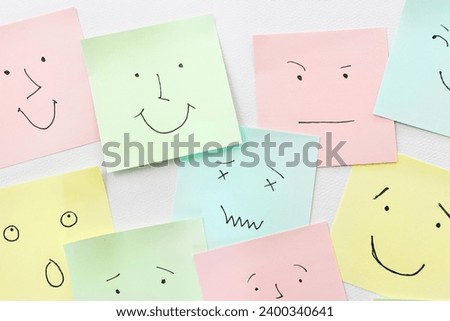 Top view image of notes with sketches of face emotions