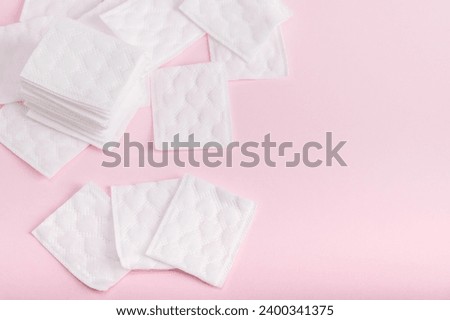 Rectangular cotton pads on a pink background. Copy space.