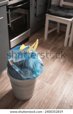 Plastic garbage bag from the trash bin in the apartment Royalty-Free Stock Photo #2400352819