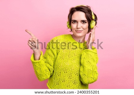 Photo of youngster girl in jumper direct finger mockup link website earphones she bought on aliexpress isolated over pink color background