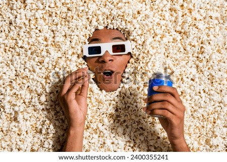 Photo of excited shocked guy spend evening weekend watch tv shows with pop corn lemonade can isolated background