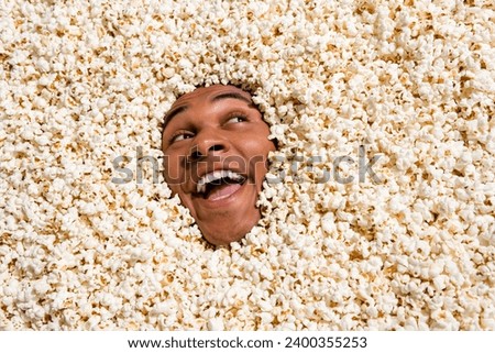 Photo of curious interested guy look empty space enjoying incredible ads for cinema movie tickets isolated pop corn background