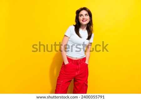 Photo of lovely pretty woman with brunette hair dressed t-shirt look at proposition empty space isolated on yellow color background