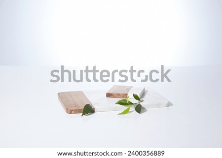 cutting board made of wood and marble isolated against a white background. An empty cutting board for display cosmetic products, food and props Royalty-Free Stock Photo #2400356889