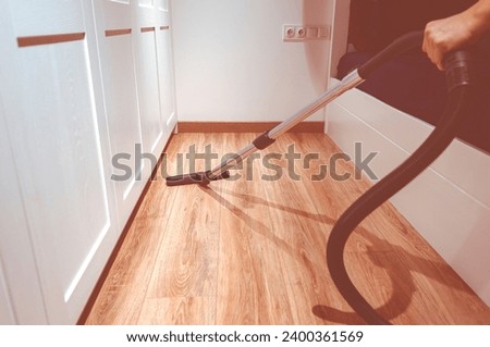 Cleaning content. A man is pee-licking the floor in an apartment. Cleaning of home and office