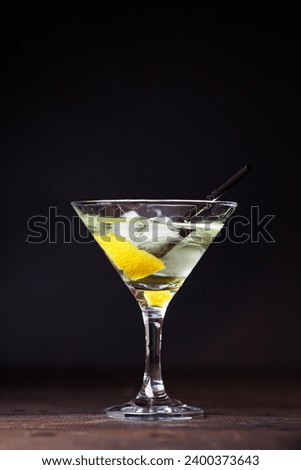 Martini in  glasses. Alcoholic cocktail on a black background
