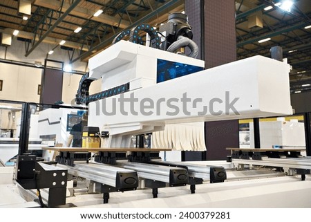 CNC machining center woodworking industrial on factory Royalty-Free Stock Photo #2400379281