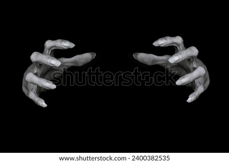 Bony pale male hands of vampire or dead with sharp nails in the dark. Monsters fingers try to grab something, low key, selected focus. Halloween, Samhain, witchcraft, evil, demon and horror concept. Royalty-Free Stock Photo #2400382535