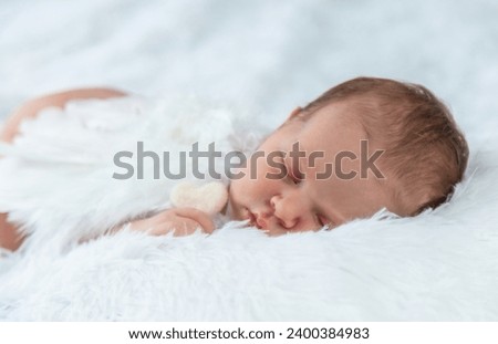 Newborn angel photo session in a suit. Selective focus.
