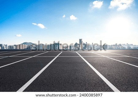 parking lot with city skyline Royalty-Free Stock Photo #2400385897