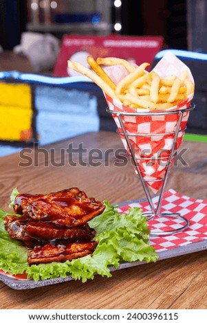 photograph of snacks served in a popular way, with the decoration of classic red checkered paper in a blurred background