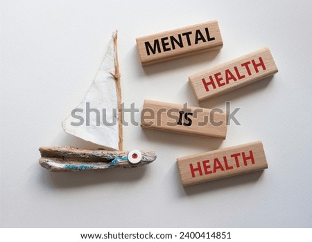 Mental Health symbol. Wooden blocks with words Mental Health is Health. Beautiful white background with boat. Medical and Health concept. Copy space.