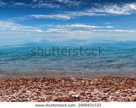 a beautiful pebble beach under a sunny cloudy sky