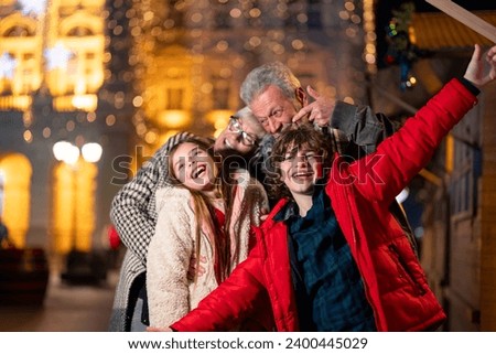 Happy smiling family celebrating Christmas outdoors.