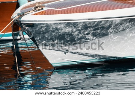 Sun glare on glossy board boats, azure water, tranquillity in port Hercules, bows of moored boats at sunny day, megayachts, Monaco, Monte-Carlo