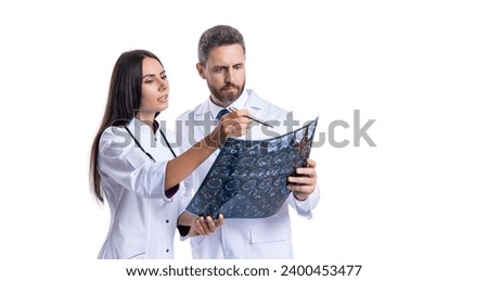 Two Medical discuss MRI Scans. doctor neurologist mri in studio. doctor oncology in mri or ct room of a modern hospital. Doctor examine MRI picture. Neurologist diagnose brain. banner Royalty-Free Stock Photo #2400453477