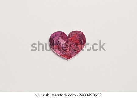Paper heart on white background.  Heart from colored paper ribbons on a white background in the style of quilling. Happy valentine day. Hand made of paper quilling technique. Copyspace. Royalty-Free Stock Photo #2400490939